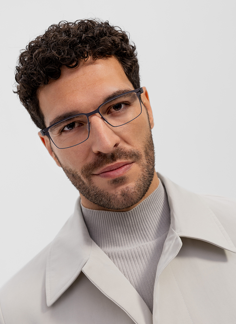 OVVO Optics portrait of a man wearing blue rectangular optical glasses and a light coat