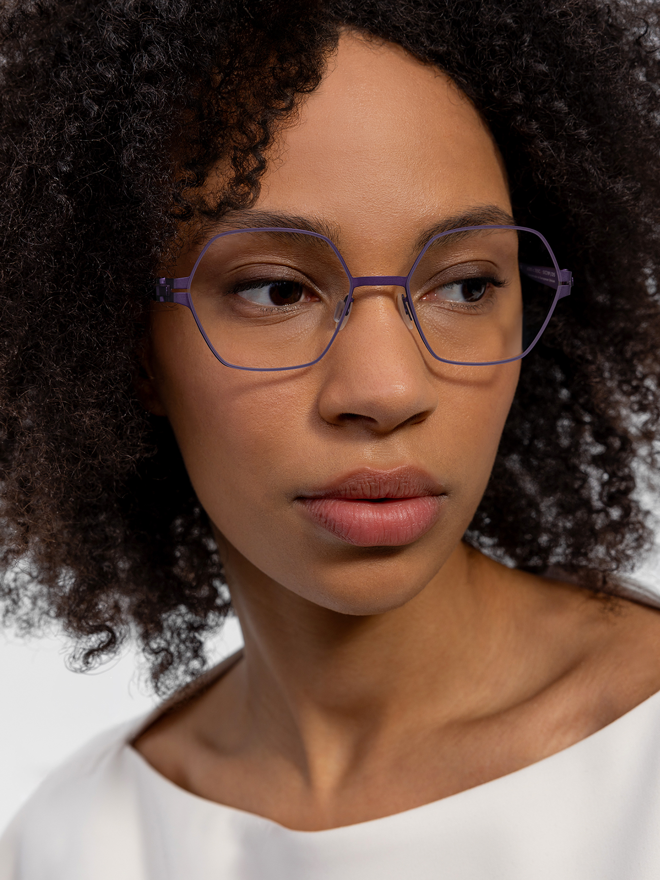 OVVO Optics close-up portrait of a woman wearing blue geometric optical glasses