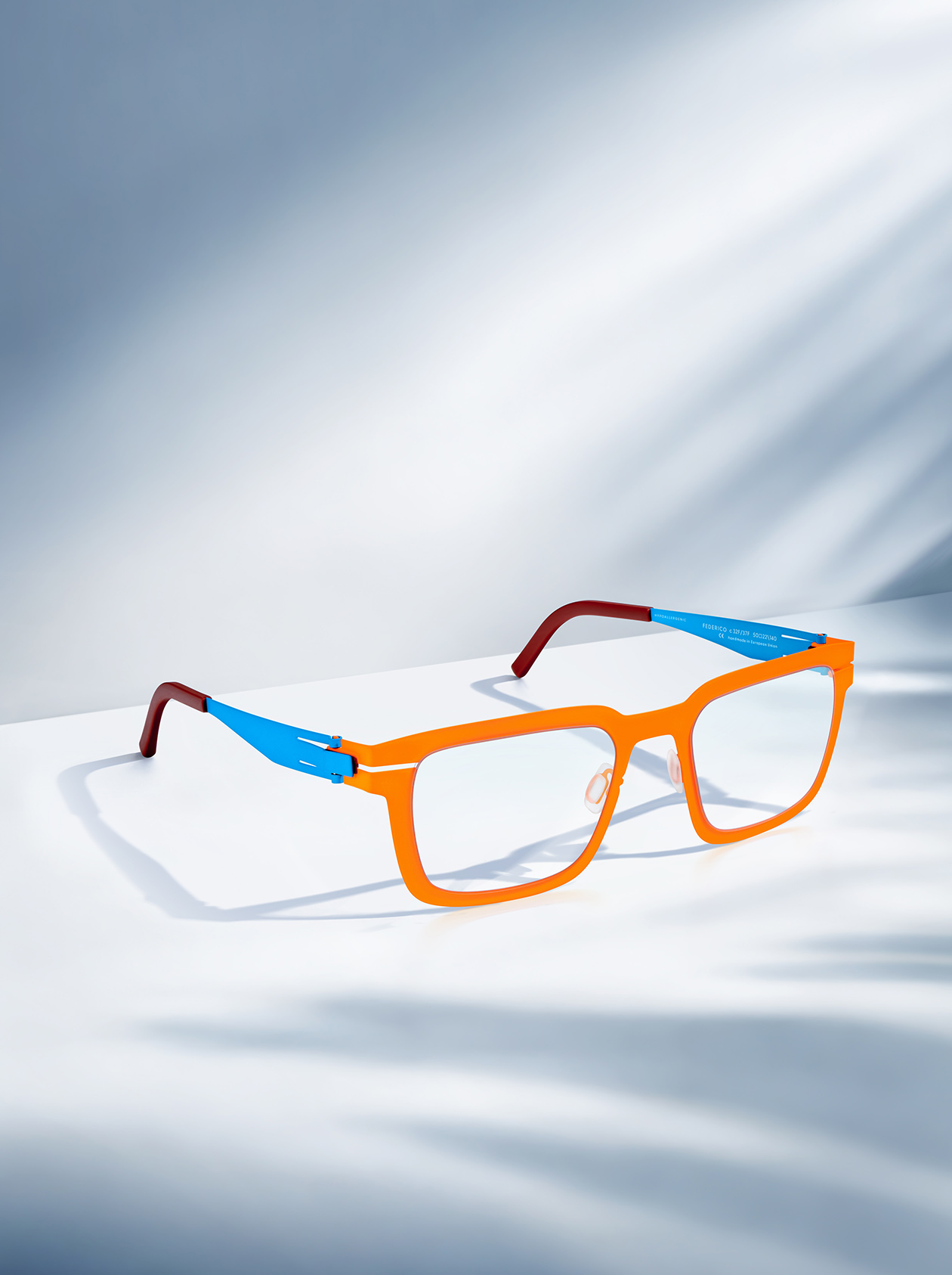 OVVO Optics red round optical frame styled with a crystal prism in a studio product shot
