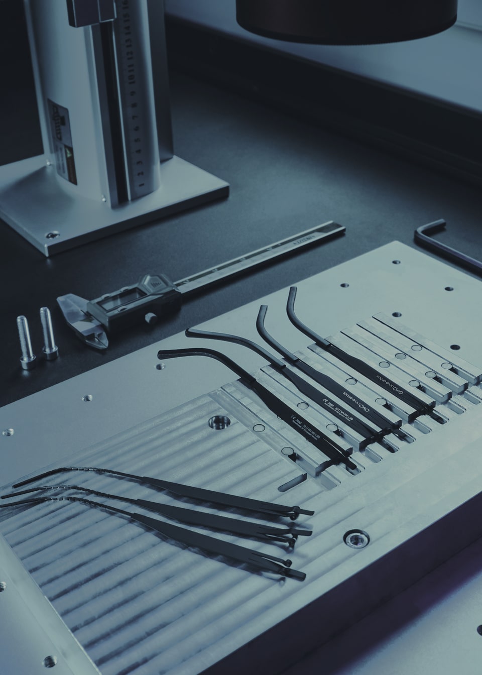 Technical close-up of OVVO Optics patented screwless hinge and surgical steel technology.