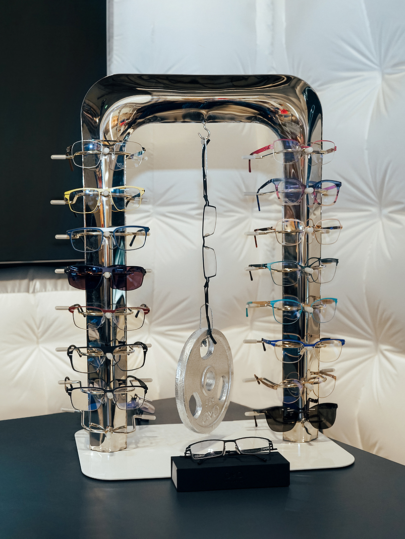 Artistic in-store eyewear display unit with multiple frame configurations for retail showrooms.