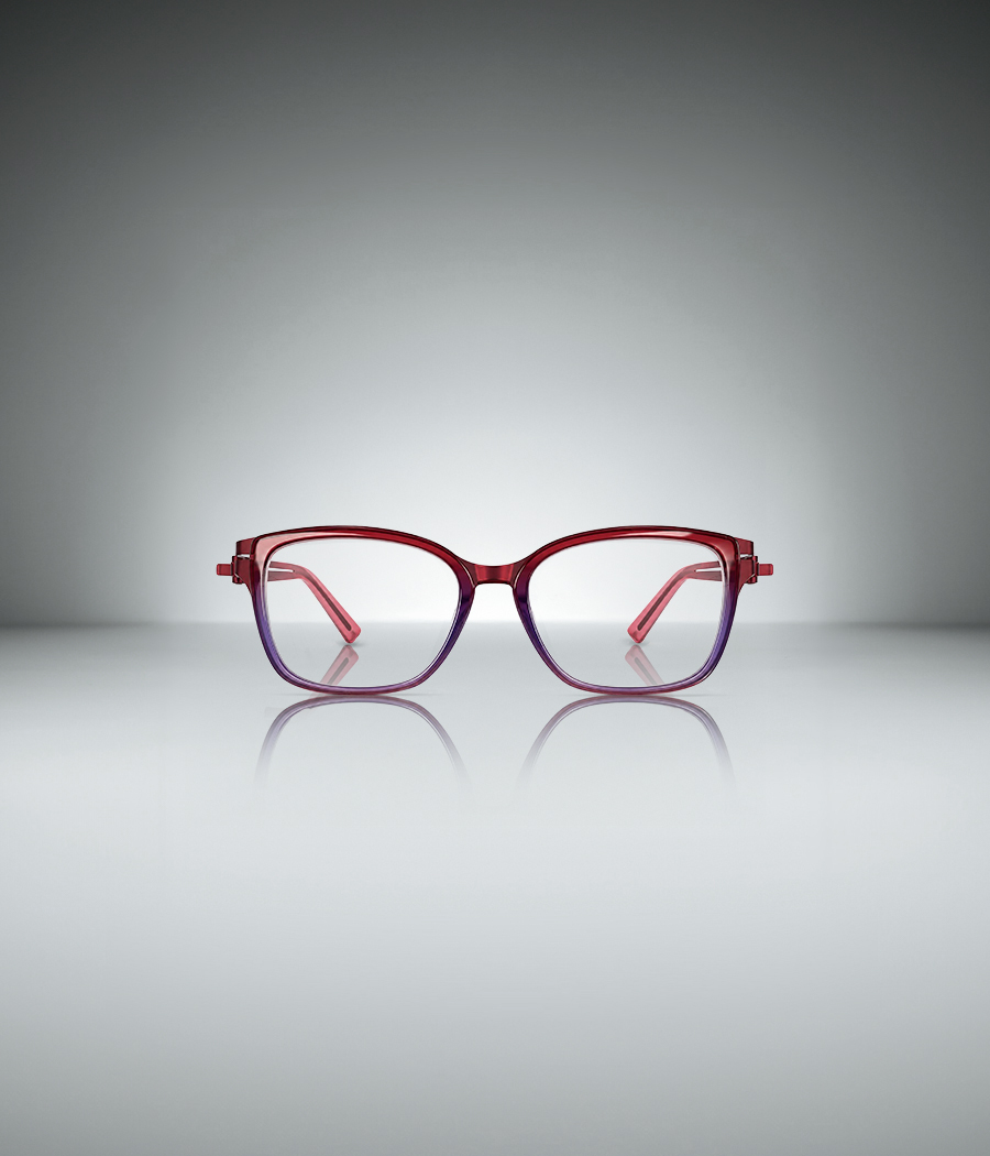 OVVO Optics DUO Marla upswept optical frame with a red-to-purple ombré finish reflected on a light gray studio surface