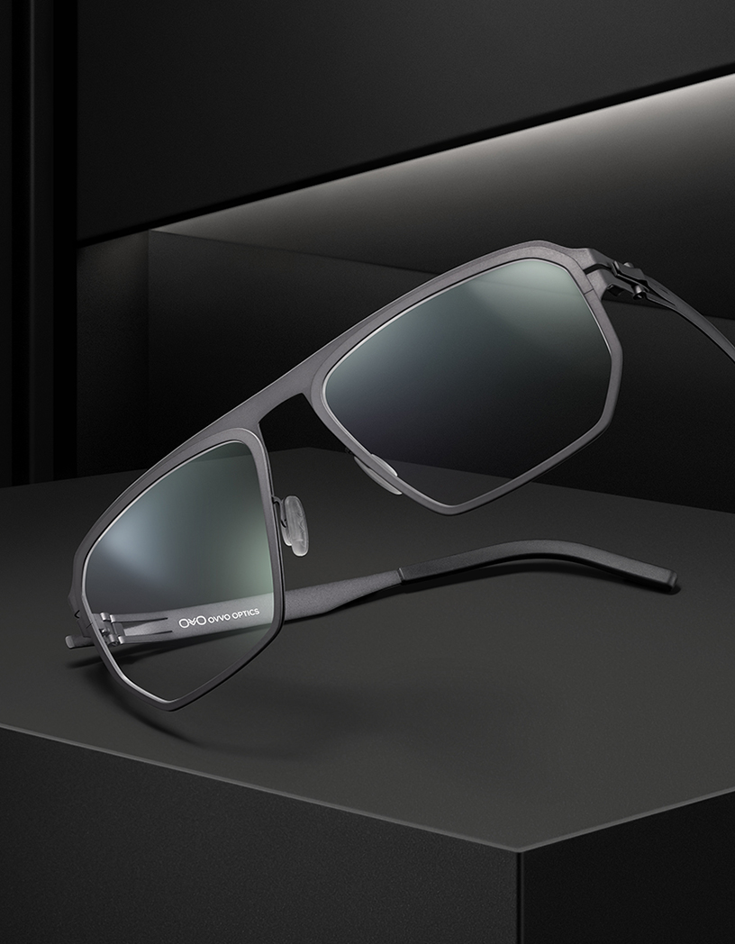 OVVO Optics Ti2 Expanded gray titanium sunglasses angled on a dark studio set