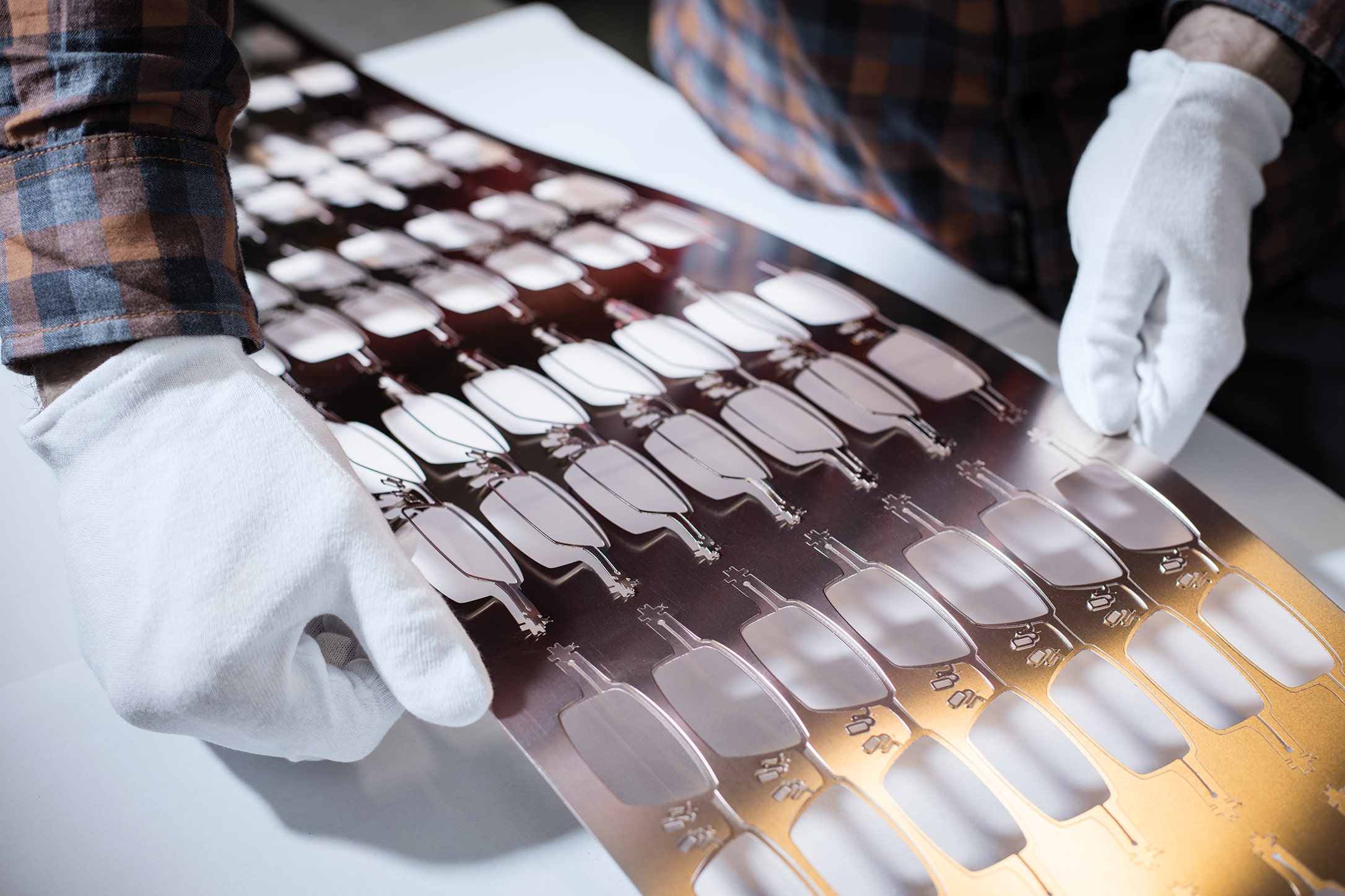 Advanced eyewear manufacturing process using CAD/CAM and robotics for precision engineering.