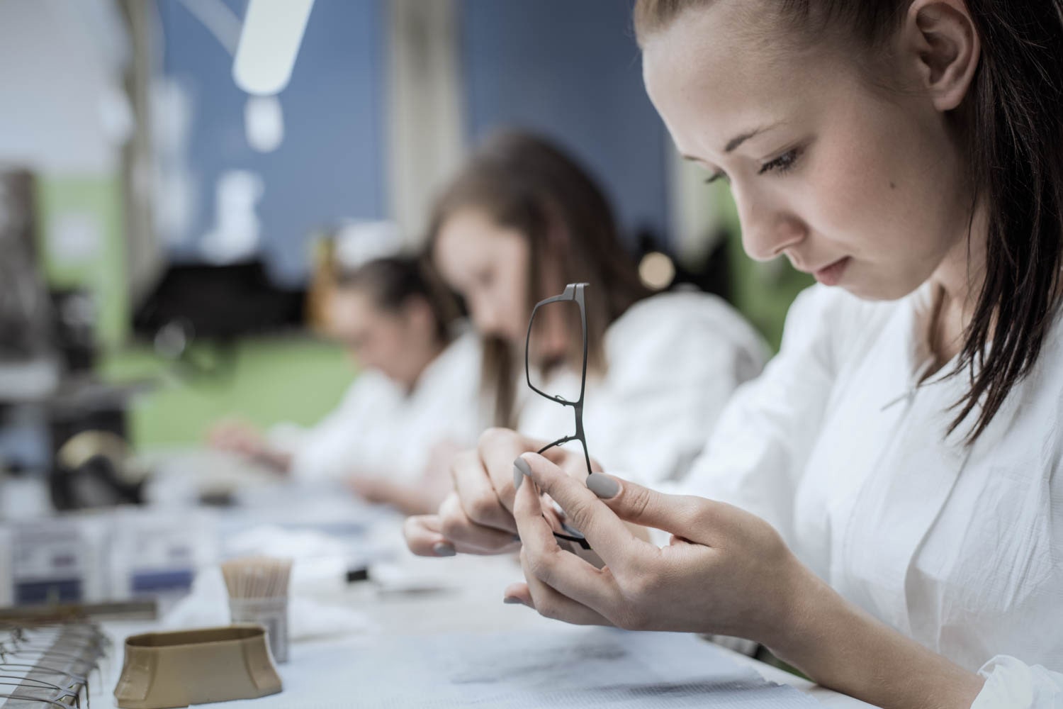 OVVO Optics in-house experts performing comprehensive quality control and lab-grade testing on eyewear frames.